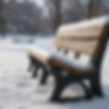 A close-up of freshly fallen snow on park benches, emphasizing the tranquility of winter in an urban environment.